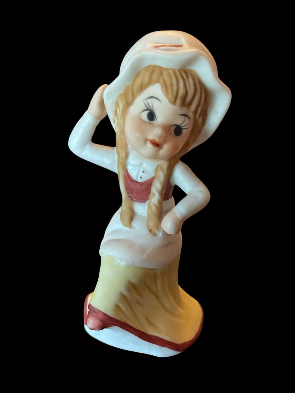 UCGC glass figurine girl with bonnet and braids sitting with posing hand UCAGO